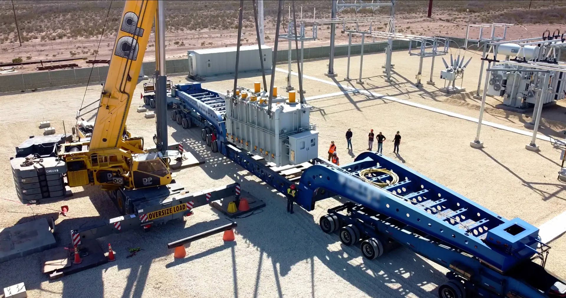 Bear Down Logistics crane assisted loading of an oversize power transformer onto a multi axle lowboy trailer at a substation
